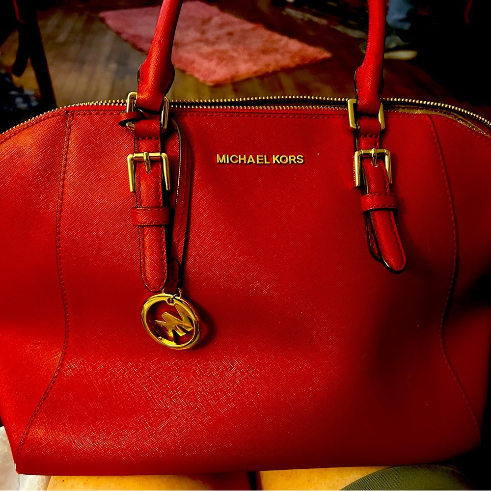MK red bag Has a few minor scratches in the back that can probably be cleaned